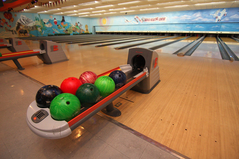 photo showing bowling balls at a bowling alley