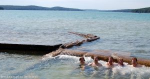 photo of five people in a lake