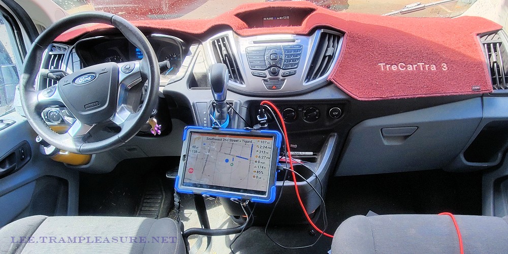 Photo showing tablet with navigation app mounted near driver's seat.