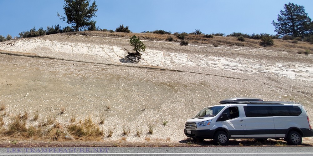 Photo showing van next to major road cut on Highway 39 in the Modoc National Forest.