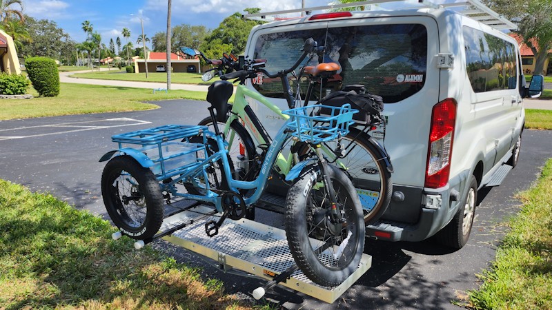 photo showing bicycle and trike loaded on rack